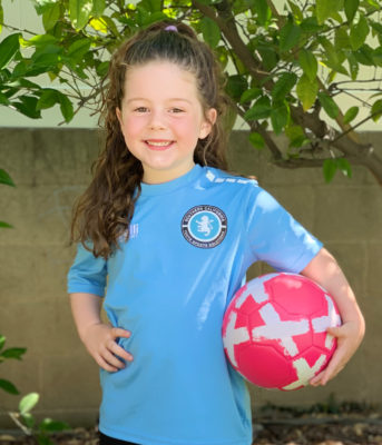 little girl with her soccer ball ready to play soccer with coach matt at her soccer class