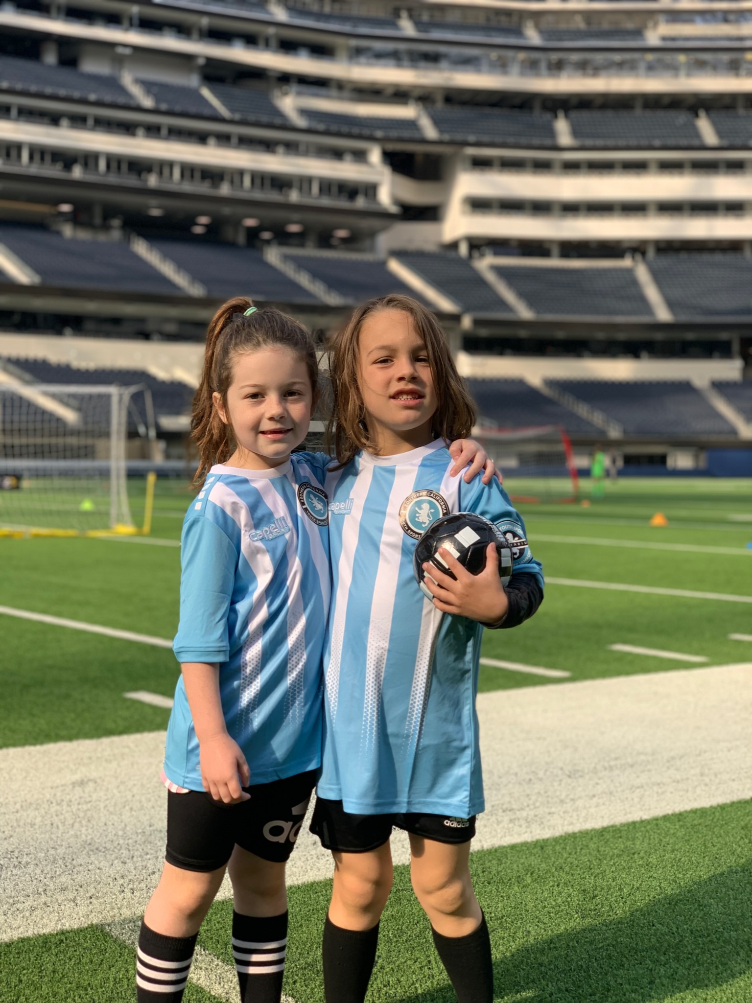 boy and girl playing soccer. they love their soccer class. they love their soccer coach