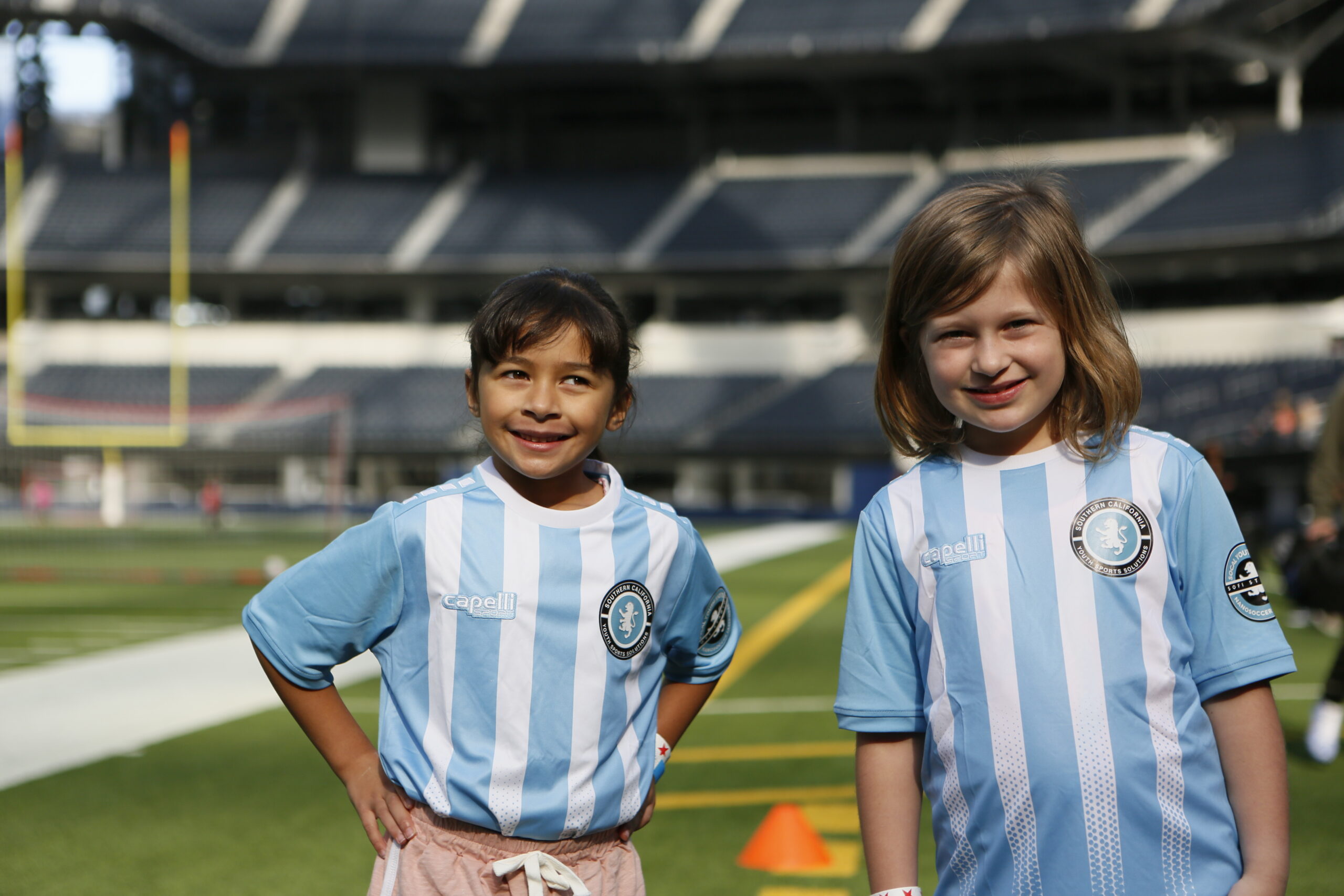 2 soccer girls playing soccer in their professionally coaches soccer class