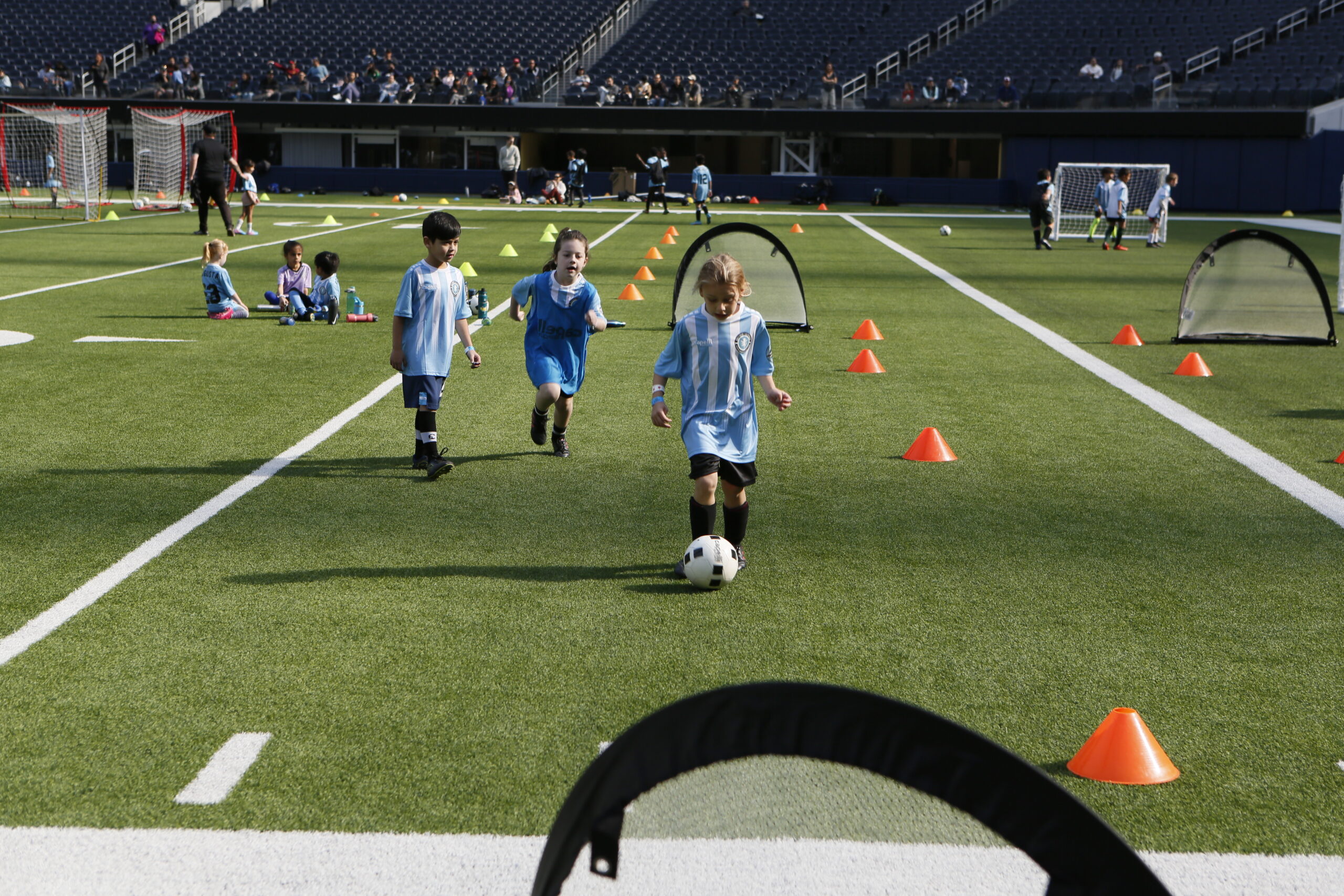 2 girls playing soccer in a soccer class. Girls soccer is taught by socal youth sports. the girls are aged between 7 and 11 and play soccer in their class