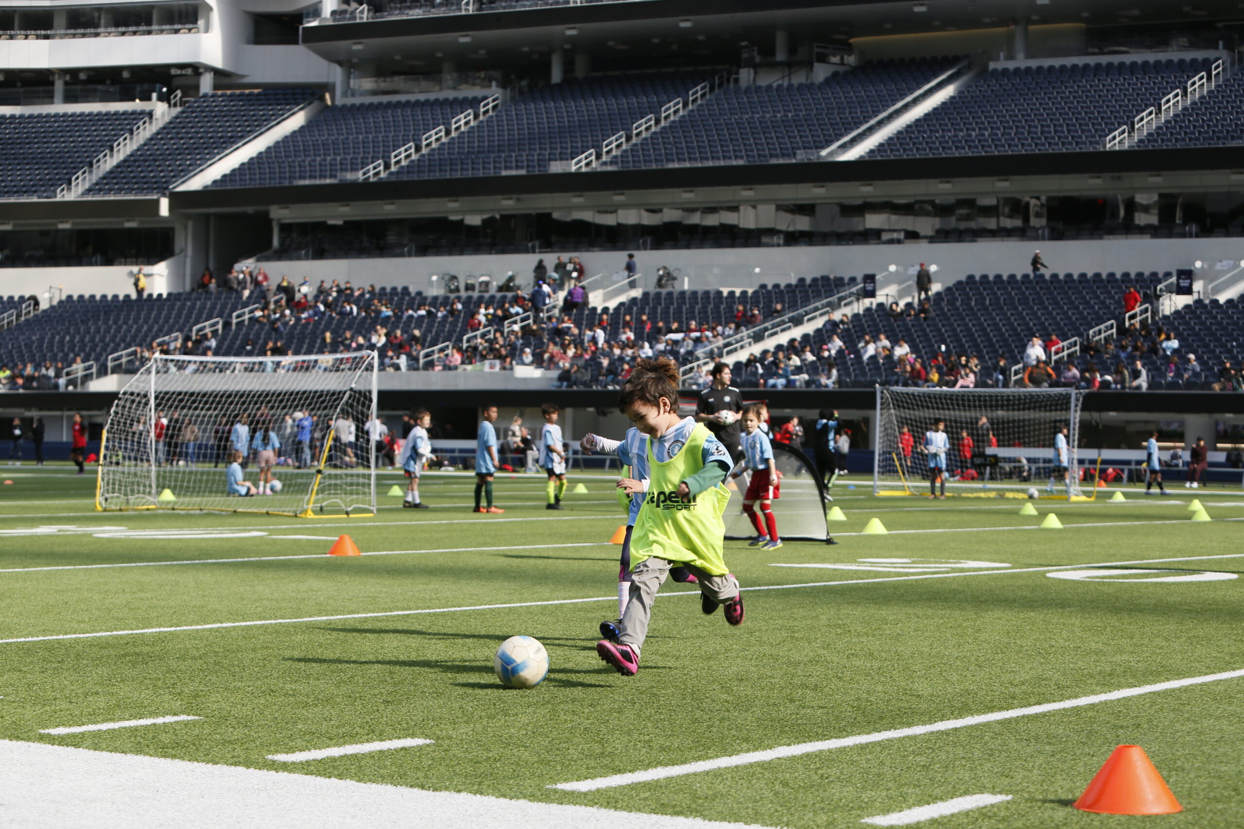 Pasadena children dribbling in a vibrant youth soccer game