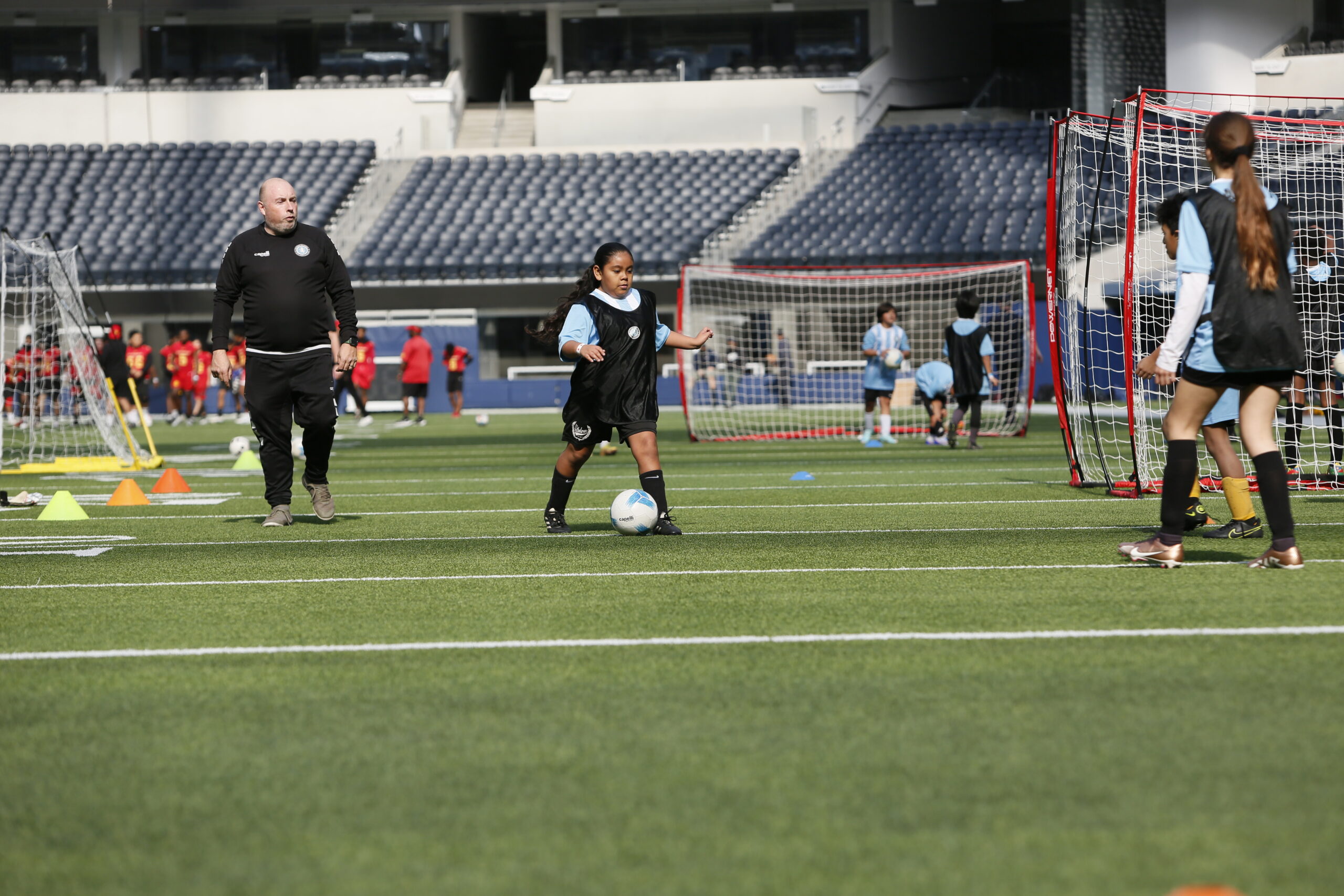 Children in soccer uniforms playing a friendly match in Pasadena