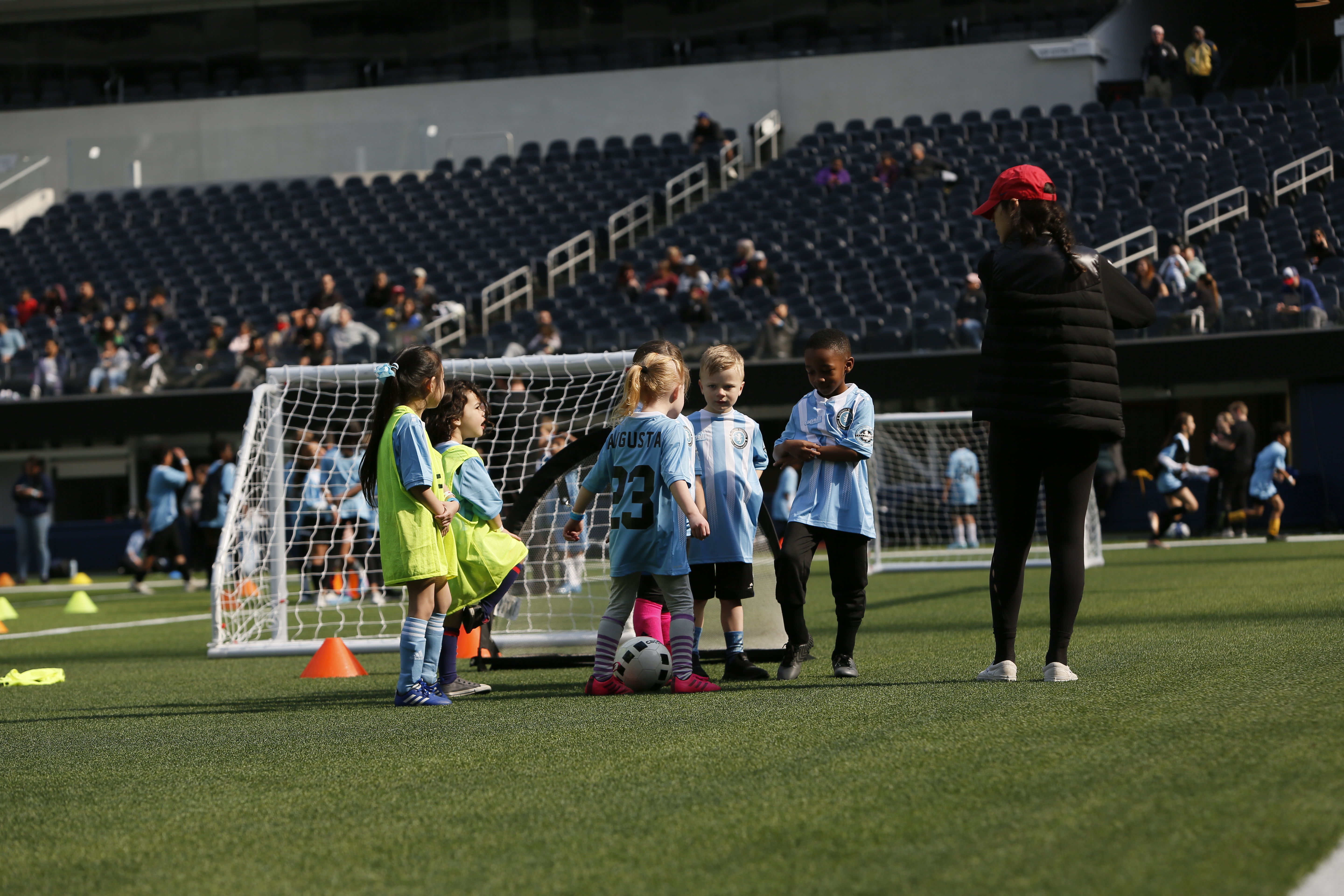 Coach and kids discussing strategies during a Pasadena soccer league game