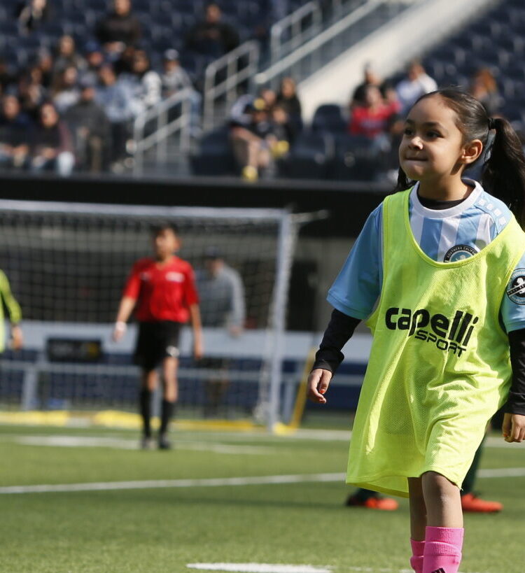 Girl playing Soccer in her soccer class