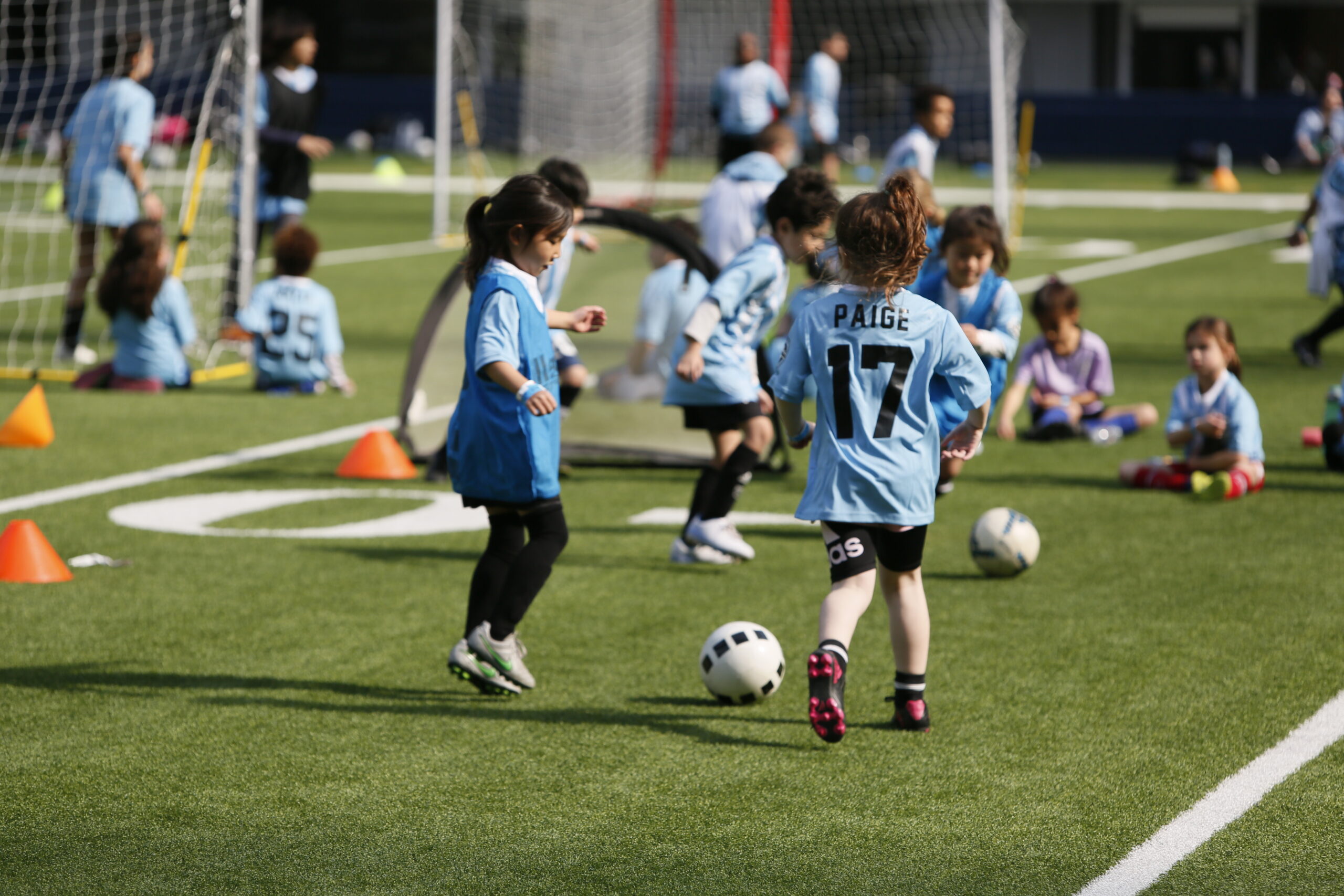 Girls playing soccer. Soccer girls in a girls soccer class.