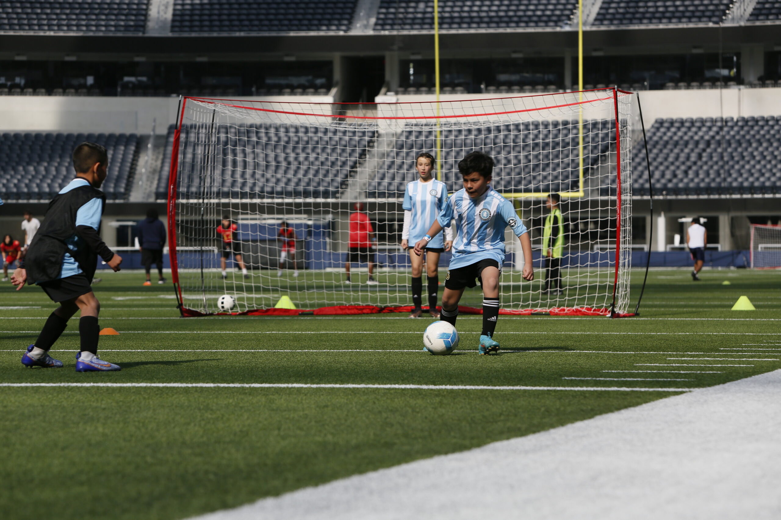 8 year old boy playing in a soccer class. professionally coached soccer class.
